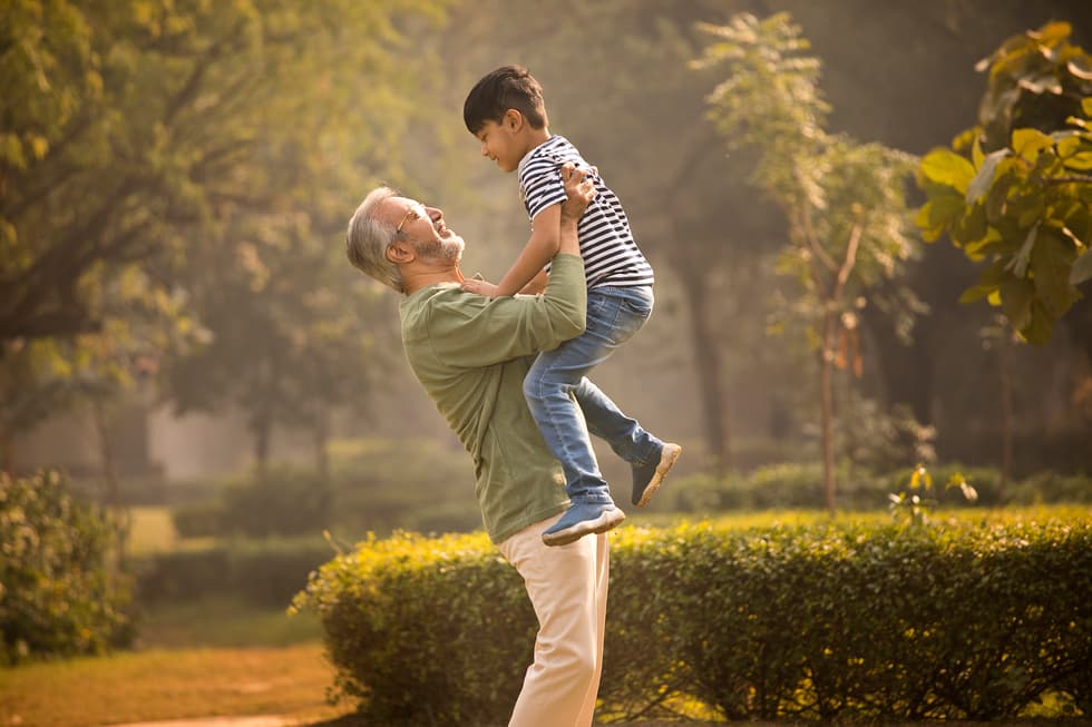 A man lifting up his grandson