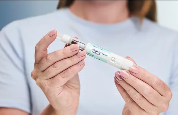 Woman holding injectable pen