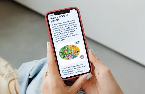 Person reading an NHS article on their phone