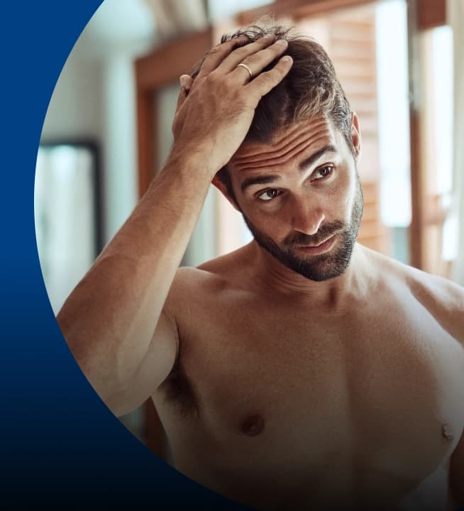 Man checking his hair in the mirror