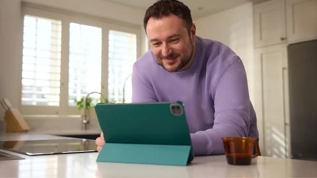 Photo of a man using a tablet