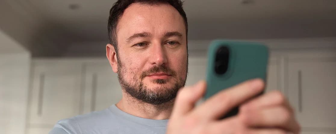 Person looking at phone representing hair loss treatment