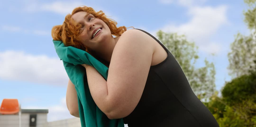 Woman drying her hair with a towel
