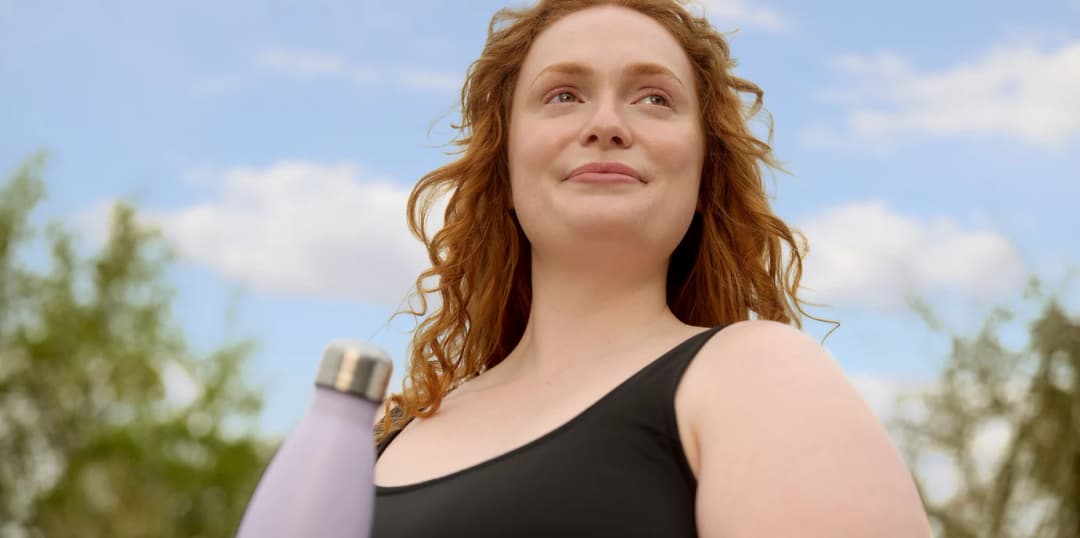 Woman holding a water bottle outdoors