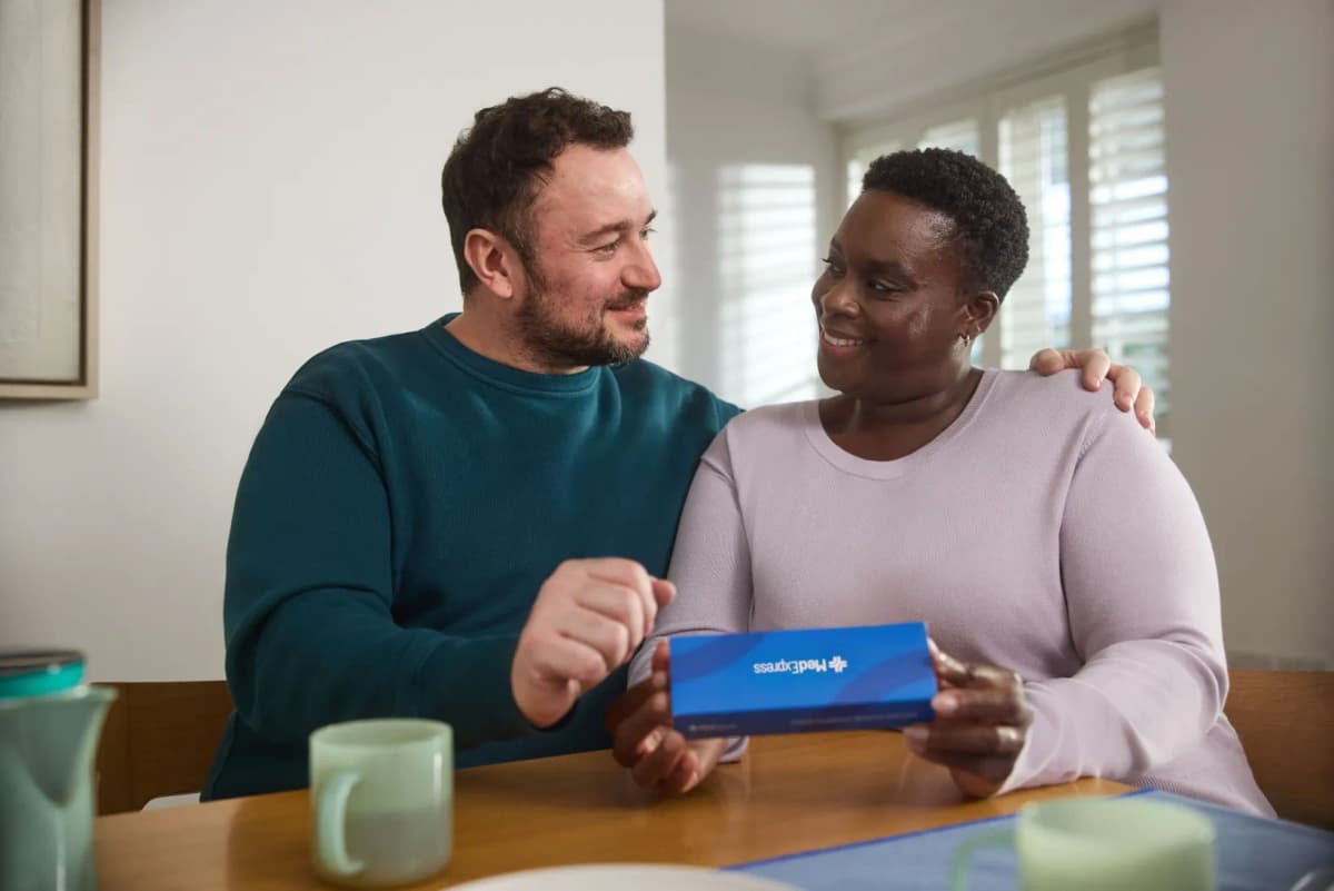 A couple reviewing a MedExpress delivery box together