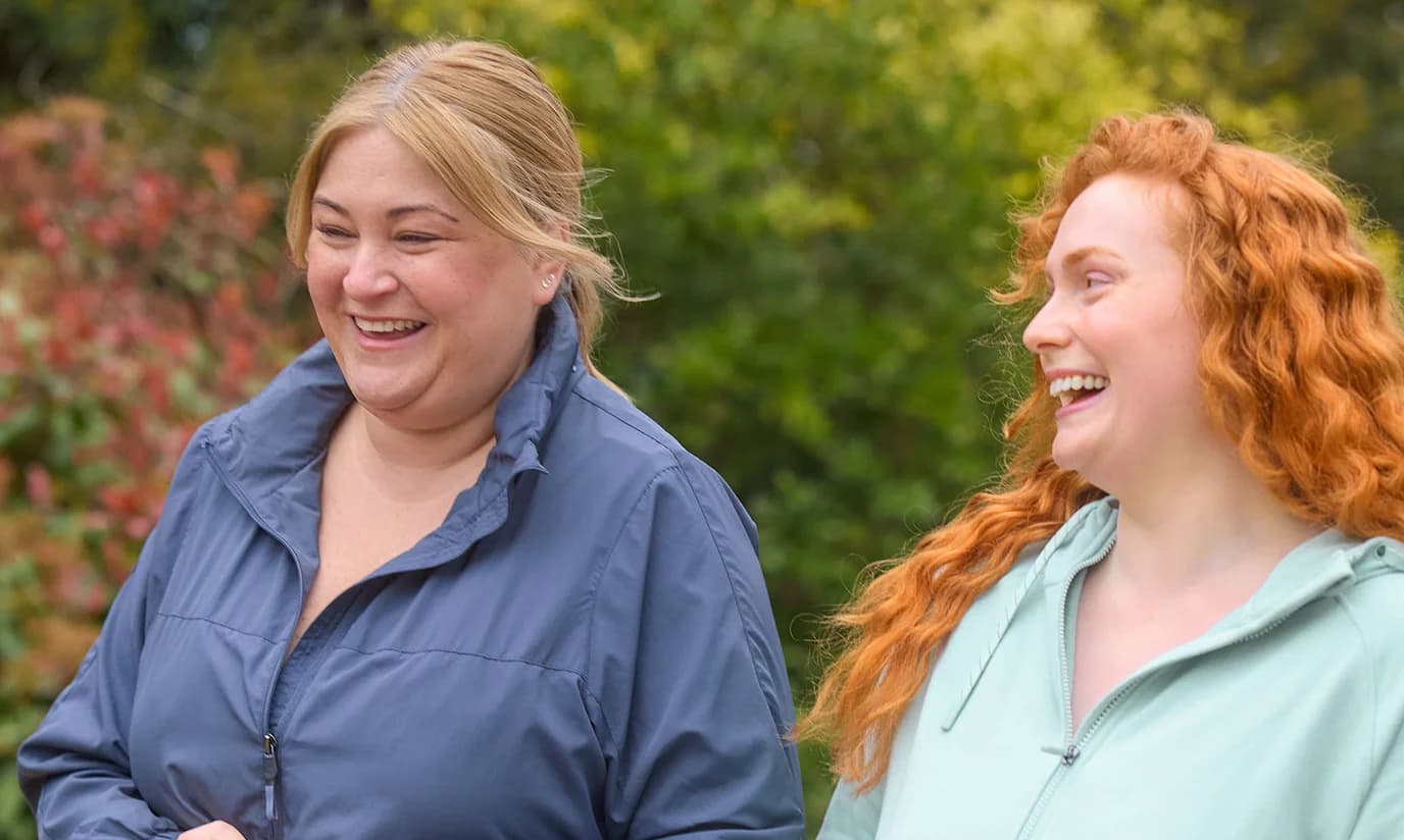 Two women laughing outdoors