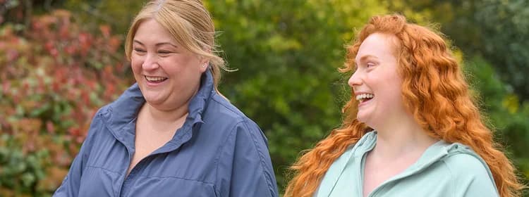 Two women laughing outdoors