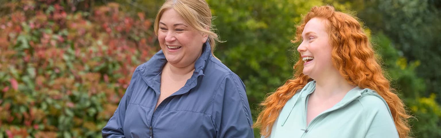 Two women laughing outdoors